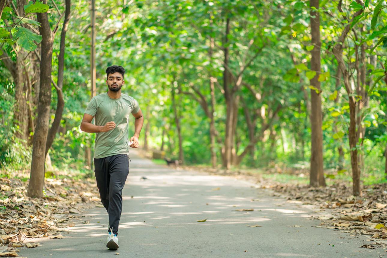 Young man running in the park at morning